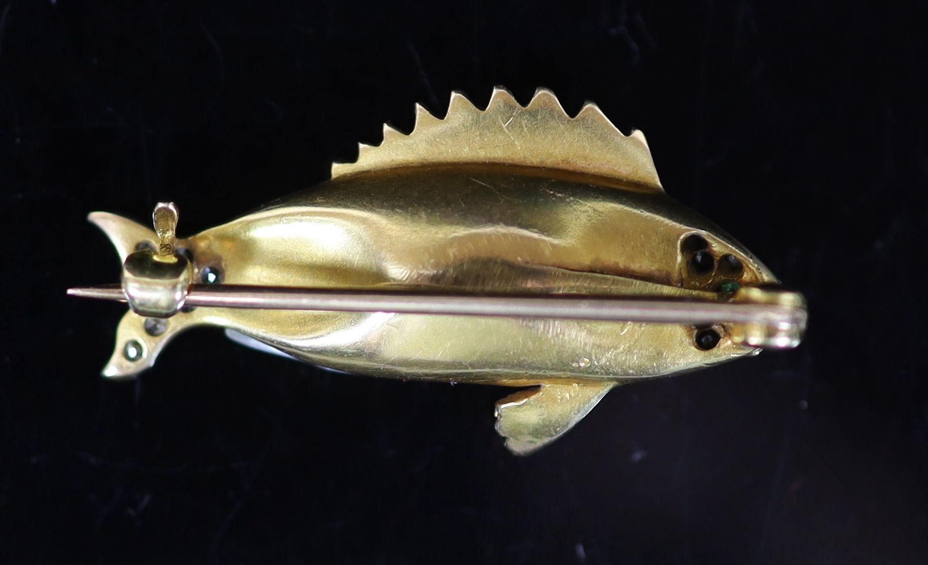 A gold, baroque pearl, garnet and diamond set brooch, modelled as a fish